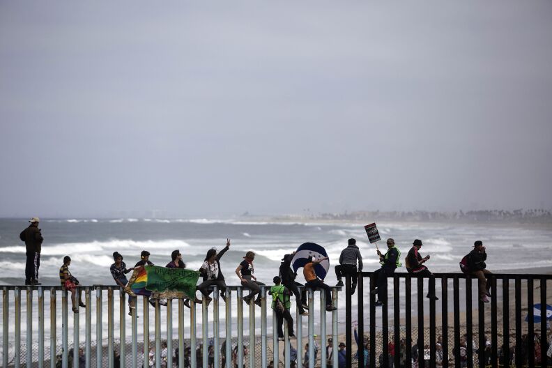 Central American migrants traveling in the "Migrant Via Crucis" caravan demonstrate at the US/Mexico Border at Tijuana's beaches in Mexico, on April 29, 2018