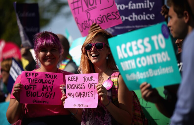 WASHINGTON, DC - JUNE 30:  Supporters of employer-paid birth control rally in front of the Supreme Court before the decision in Burwell v. Hobby Lobby Stores was announced June 30, 2014 in Washington, DC. The high court ruled 5-4 that requiring family-owned corporations to pay for insurance coverage for contraception under the Affordable Care Act violated a federal law protecting religious freedom.  (Photo by Chip Somodevilla/Getty Images)