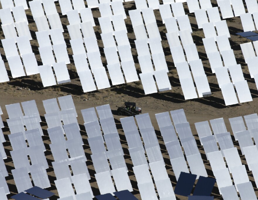 Some of the 300,000 computer-controlled mirrors, each about 7 feet high and 10 feet wide, reflect sunlight to boilers that sit on 459-foot towers. The sun's power is used to heat water in the boilers' tubes and make steam, which in turn drives turbines to create electricity Tuesday, Feb. 11, 2014 in Primm, Nev. The Ivanpah Solar Electric Generating System, sprawling across roughly 5 square miles of federal land near the California-Nevada border, will be opened formally Thursday after years of regulatory and legal tangles. (AP Photo/Chris Carlson)