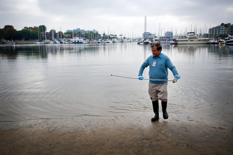 Pravin Patel, a lab technician in the Environmental Monitoring Division for Los Angeles County, takes samples of the beach water in Marina del Rey on Monday, Aug. 5.