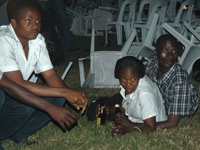 Survivors are seen at an Ethiopian-owned restaurant in the Kabalagala area of Kampala late Sunday, moments after twin bomb blasts tore through the crowds of football fans watching the World Cup final, killing 64 and wounding scores more.