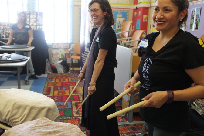 ESL teacher Connie McOsker, community arts coordinator for the Grand Vision Foundation, stands with Carmen, a student in a Taiko, Japanese drumming class -- a weekly component of a class for adult English learners.