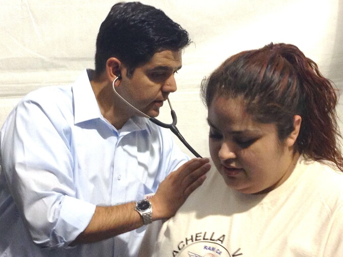 Rep. Raul Ruiz examines patient Maricela Hernandez at a free medical clinic in Indio. Hernandez had been complaining of back pain.