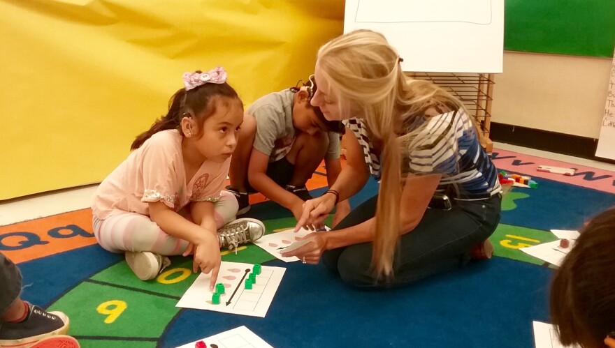Teacher Tiffany Ward works with a small group of students on how words sound in the USC's Come Read with Me program for English learners who are deaf or hard of hearing.