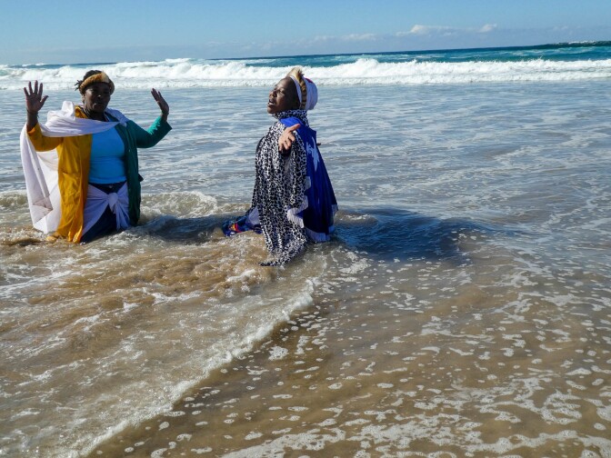 Silungile (right) used a tripod and a timer to capture this moment of attempting to commune with her ancestors. She is dancing with her <em>sangoma</em> (traditional healer) in Durban, South Africa, and has lived with HIV for many years.