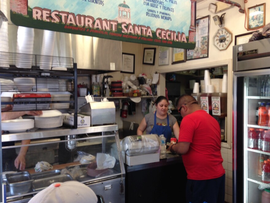 A lunchtime customer orders at the Santa Cecilia Restaurant, one of the small businesses lining Mariachi Plaza.