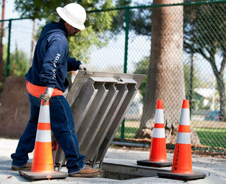 Public Works Crew Leader Mike Seguin shuts a manhole cover above a storm water storage area at Sun Valley Park. Water gathered from Elmer Avenue is directed to the park for irrigation.
