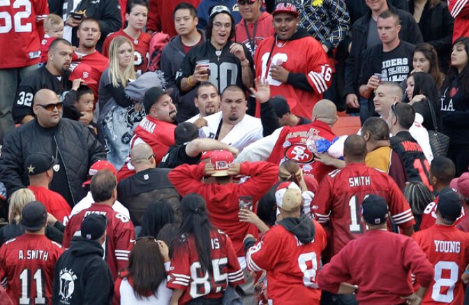 In this Aug. 20, 2011 photo, football fans fight in the stands during a preseason NFL football game between the San Francisco 49ers and the Oakland Raiders in San Francisco. After two men were shot and wounded following the preseason game, the NFL and the mayors of the two cities jointly called for an end to "intimidation" and acts of violence at sporting events.