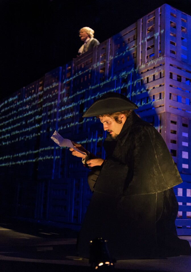 Charles Darnay (Tavis Doucette) reads the letter from Gabelle pictured behind (Kasey Mahaffy) in "A Tale of Two Cities."