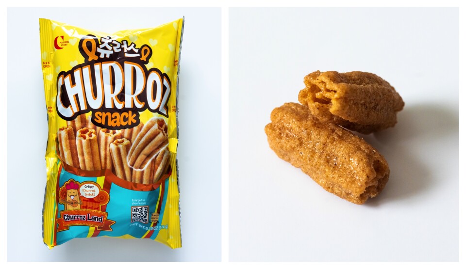 A split image: a yellow snack colored back with a white and orange letter with the image of the churroz snacks it contains. On the right, two churroz snacks are laid on top of each at an angle. The snacks are light-ish brown and covered in sugar crystals. 