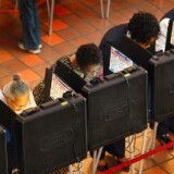 People cast their votes at a polling station set up at the Miami-Dade Government Center on October 18, 2010 in Miami, Florida. Florida residents headed to the polls to cast votes on the first day of early voting in the midterm elections.