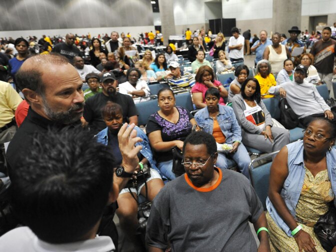 Bruce Marks (left), CEO of the nonprofit organization Neighborhood Assistance Corporation of America, talks to homeowners waiting to meet with bank representatives at a NACA event in Los Angeles in September.