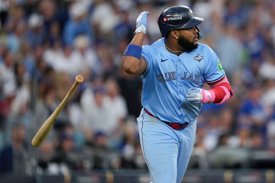 Toronto Blue Jays' Vladimir Guerrero Jr. flips his bat as he runs.