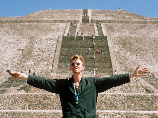 David Bowie stretches his arms in front of the Pyramid of the Sun at Teotihuacan during his trip to Mexico City in 1997. 