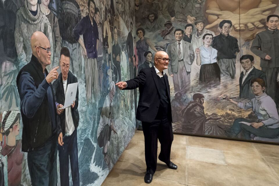 Artist and curator of the "Winds from Fusang: Mexico and China in the Twentieth Century" exhibit, Shengtian Zheng, of Canada, talks about a Mexican artist Diego Rivera inspired mural he helped paint during the media tour of the newly renovated USC Pacific Asia Museum, December 6, 2017.  (Photo/Gus Ruelas)