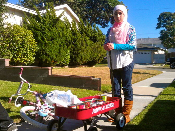 Keya stops the wagon in front of a neighbor’s house.