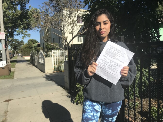 Jeanette Ruiz holds a copy of the final exam that included a question she said made her feel "personally attacked."
