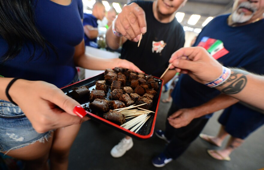 Care-carrying medical marijuana patients sample the brownies at Los Angeles' first-ever cannabis farmer's market at the West Coast Collective medical marijuana dispensary, on the fourth of July, or Independence Day, in Los Angeles, California on July 4, 2014 where organizer's of the 3-day event plan to showcase high quality cannabis from growers and vendors throughout the state. 