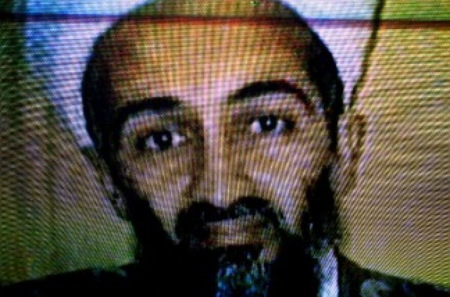 Afghans watch television coverage announcing the killing of Al-Qaeda leader Osama bin Laden at an electronics store on May 2, 2011 in Kabul, Afghanistan.