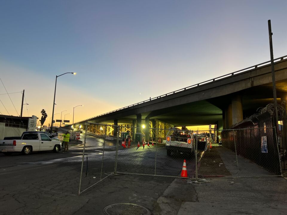 Wood scaffolding is visible under a raised roadway