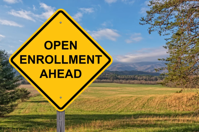 A yellow sign reads Open enrollment ahead