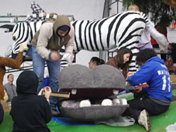 Volunteers help assemble to the crazy monkey barbershop for Cal Poly Universities 2010 Tournament of Roses float, "Jungle Cuts".