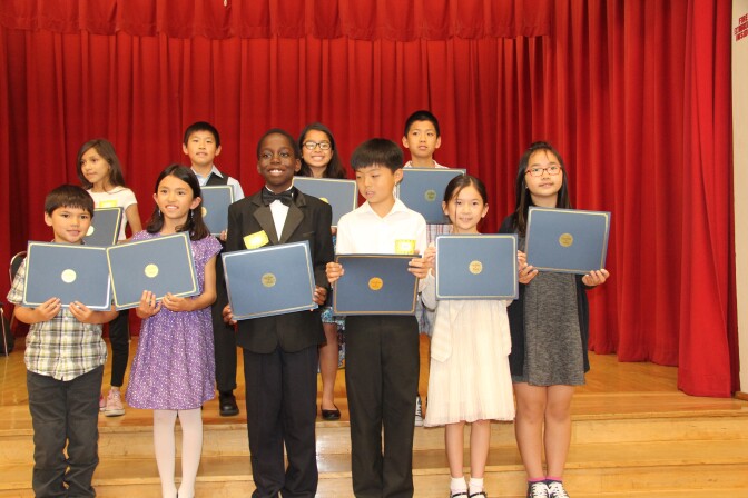 Kevon Fortune, center, stands with other violin students who received scholarships for private lessons. 
