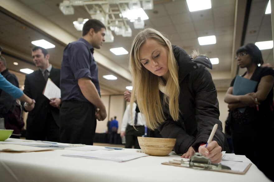 File: Intern Jenny Pazar fills out a form as she looks for a job at a job fair Dec. 2, 2011 in Portland.