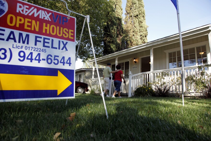 In this Nov. 4, 2010 photo, a couple arrives for the open house for a home in Los Angeles. Sales of previously owned homes slipped slightly in October as the housing market struggled in the face of high unemployment and tight credit. (AP Photo/Richard Vogel)