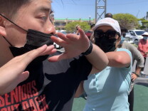 An older Vietnamese American woman practices self-defense moves on a male volunteer with the new group Seniors Fight Back outside the Asian Garden Mall in Westminster. 
