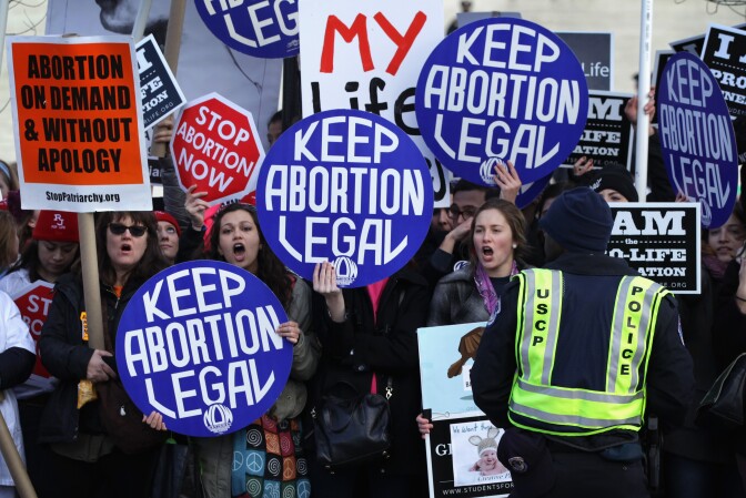WASHINGTON, DC - JANUARY 22:  Pro-choice activists shout slogans before the annual March for Life passes by the U.S. Supreme Court January 22, 2015 in Washington, DC. Pro-life activists gathered in the nation's capital to mark the 1973 Supreme Court  Roe v. Wade decision that legalized abortion.  (Photo by Alex Wong/Getty Images)
