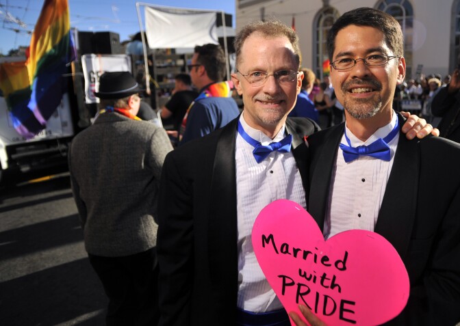 Stuart Gaffney (R) poses with his husband John Lewis (L) as celebrations ensue in the Castro neighborhood of San Francisco, California, June 26, 2012, after the US Supreme Court struck down The Defense of Marriage Act (DOMA), and declared that same-sex couples who are legally married deserve equal rights to the benefits under federal law that go to all other married couples. In another ruling, the Supreme Court cleared the way for same-sex marriages to resume in California as the justices, in a procedural ruling, turned away the defenders of Proposition 8.