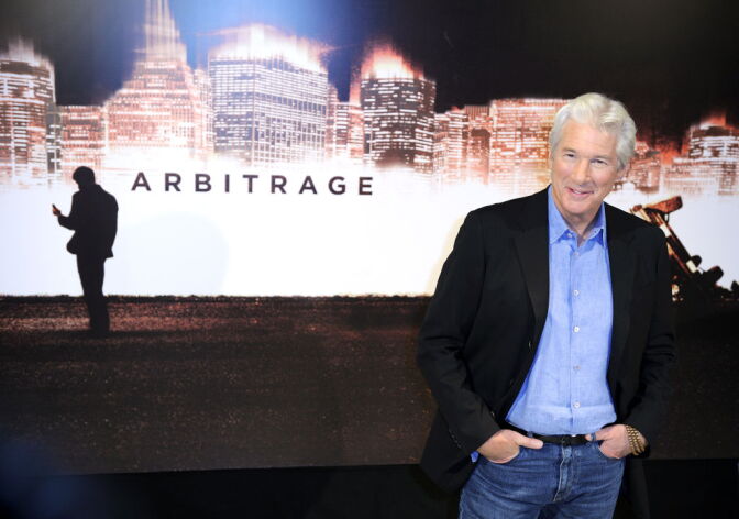 Richard Gere poses during a photocall for the movie Arbitrage on December 4, 2012 in Paris.