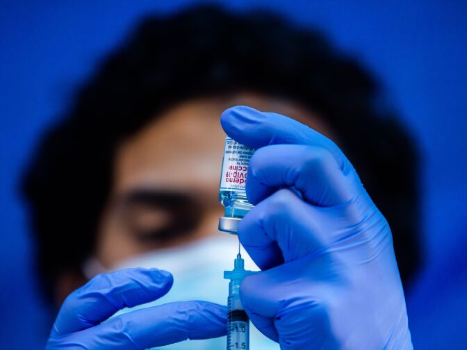 Medical worker Robert Gilbertson loads a syringe with the Moderna Covid-19 vaccine to be administered by nurses at a vaccination site at Kedren Community Health Center, in South Central Los Angeles, California on February 16, 2021. (Photo by Apu GOMES / AFP) (Photo by APU GOMES/AFP via Getty Images)