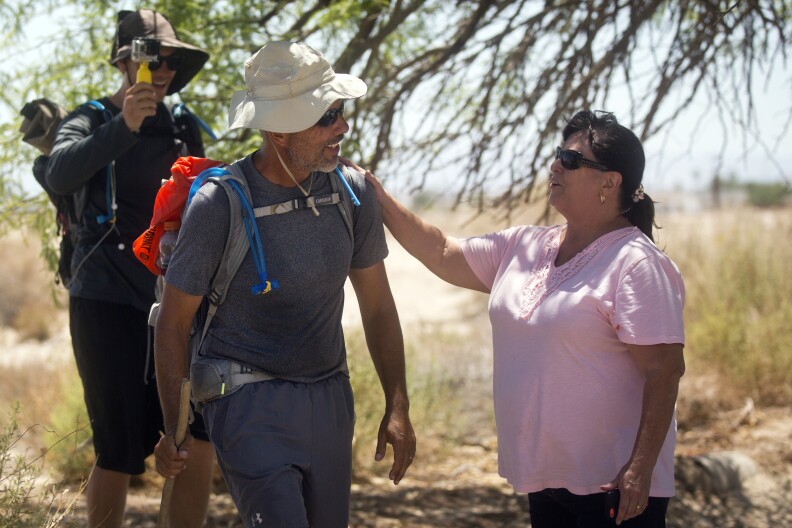 Randy Brown, left, is greeted by Mary Kay House, before Brown's stop for lunch at Vista Del Mar Clubhouse during his six-day walk around the Salton Sea on Friday, June 12, 2015. Brown is attempting to be the first person to ever walk around the shoreline of the Salton Sea, California's largest lake.