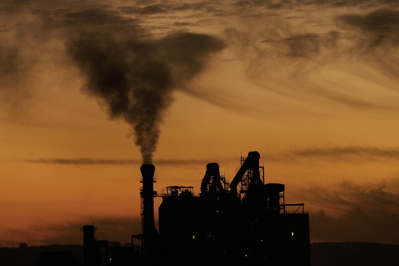 Black smoke billows from the chimeny of an  industrial plant is the northern Lebanese coastal town of Anfeh, near Tripoli, on December 15, 2009. Lebanese Prime Minister Saad Hariri headed to Copenhagen on December 15 to attend the Climate Change World Summit as UN chief Ban Ki-moon warned that negotiators face a race against time to prevent the meeting ending in catastrophic failure after developing nations staged a five-hour walkout. Pollution and climate change cost Lebanon more than half a million dollars (330 million euros) a year, the environment minister said earlier this month, adding that temperatures in the east Mediterranean country were expected to rise two degrees on average in the next four decades, and five degrees by the turn of the century.  AFP PHOTO/JOSEPH EID (Photo credit should read JOSEPH EID/AFP/Getty Images)
