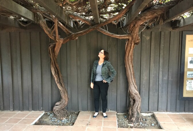 Author and historian Frances Dinkelspiel with two 150-year old mission grape vines at Avila Adobe on Olvera Street in downtown Los Angeles.