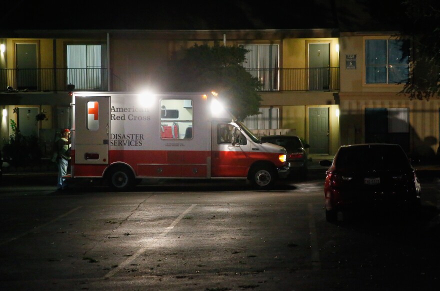 DALLAS, TX - OCTOBER 02: Volunteers from the Red Cross deliver blankets and other supplies to a unit at the Ivy Apartments, where the confirmed Ebola virus patient was staying, on October 2, 2014 in Dallas, Texas. The first confirmed Ebola virus patient in the United States was staying with family members at The Ivy Apartment complex before being treated at Texas Health Presbyterian Hospital Dallas. State and local officials are working with federal officials to monitor other individuals that had contact with the confirmed patient. (Photo by Tom Pennington/Getty Images)