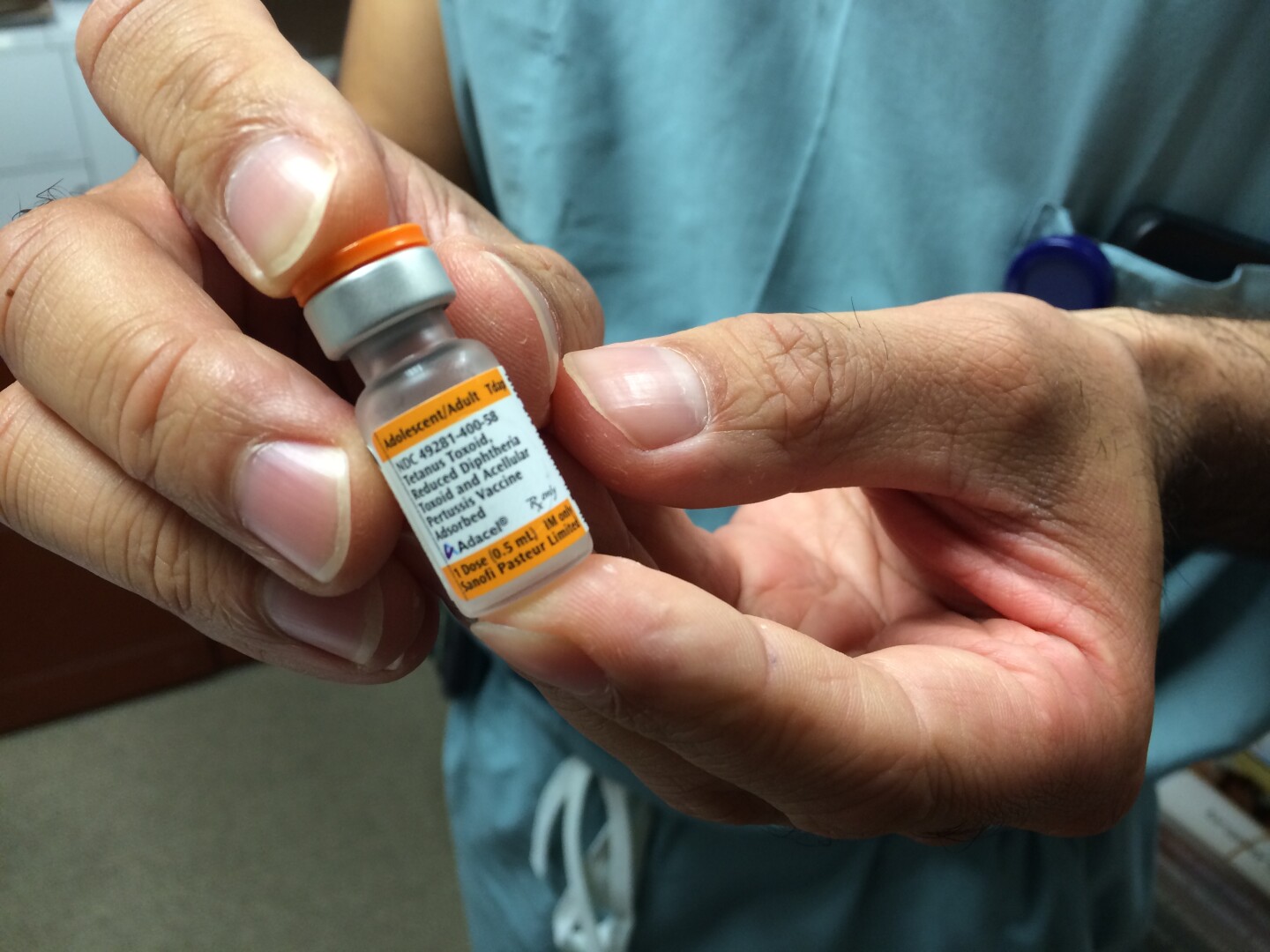 Dr. Daniel Kahn holds the Tdap vaccine, which he administers to pregnant women in their third trimester.