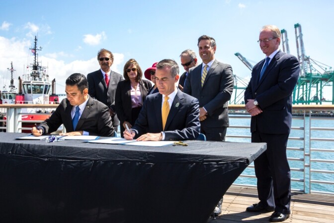 Los Angeles Mayor Eric Garcetti (right) and Long Beach Mayor Robert Garcia (left) sign a
joint declaration on Monday, June 12, 2017, setting environmental goals for their respective ports
and reaffirming their commitment to adopting the Paris climate agreement goals.
