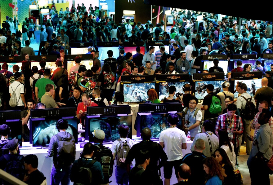 Gamers test new video games on display at the Sony Playstation area on the opening day of the Electronic Entertainment Expo, known as E3 at the Convention Center in Los Angeles, California on June 16, 2015.  Console kings Microsoft and Sony battled for players' hearts with blockbuster games and the lure of virtual worlds as the annual Electronic Entertainment Expo began in Los Angeles.      AFP PHOTO / MARK RALSTON        (Photo credit should read MARK RALSTON/AFP/Getty Images)