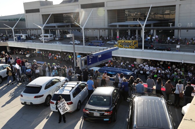 LOS ANGELES, CA - JANUARY 29:  Protesters hold signs during a demonstration against the immigration ban that was imposed by U.S. President Donald Trump at Los Angeles International Airport on January 29, 2017 in Los Angeles, California. Thousands of protesters gathered outside of the Tom Bradley International Terminal at Los Angeles International Airport to denounce the travel ban imposed by President Trump. Protests are taking place at airports across the country.  (Photo by Justin Sullivan/Getty Images)