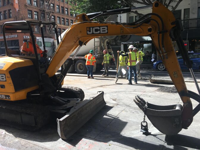 Construction crews work with heavy equipment near Sixth and Spring streets in Downtown L.A.