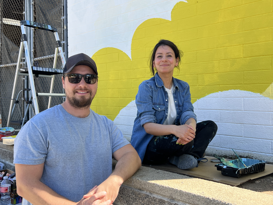 Katie Sunderalingam and a helper work on her mural for Loma Alta Park in Altadena.