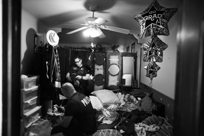 Riverside police officers look through the room of a probationer who had recently gone missing and has gang ties in Los Angeles.