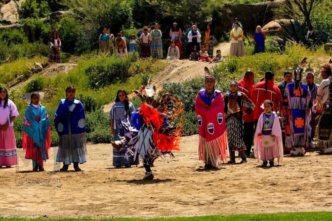Dancers and performers in Native American and Mexican traditional dress outdoors at the Ramona Pageant.