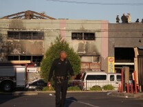 Firefighters and police at the scene of a overnight fire that claimed the lives of at least nine people at a warehouse in the Fruitvale neighborhood on December 3, 2016 in Oakland, California. The warehouse was hosting an electronic music party. 