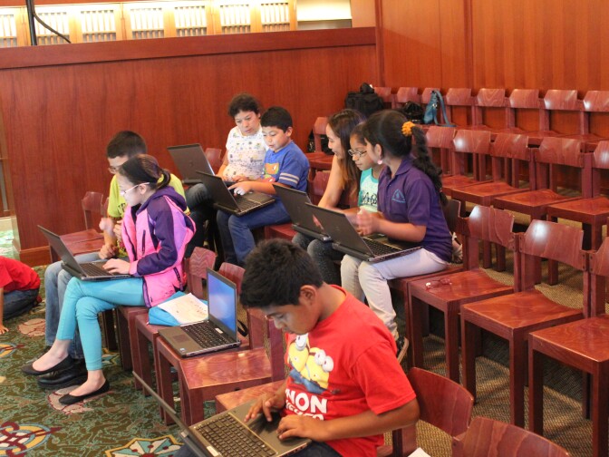 "Coder Time" students are gathered in Children's Literature Departments at L.A.'s Central Library to work on their projects