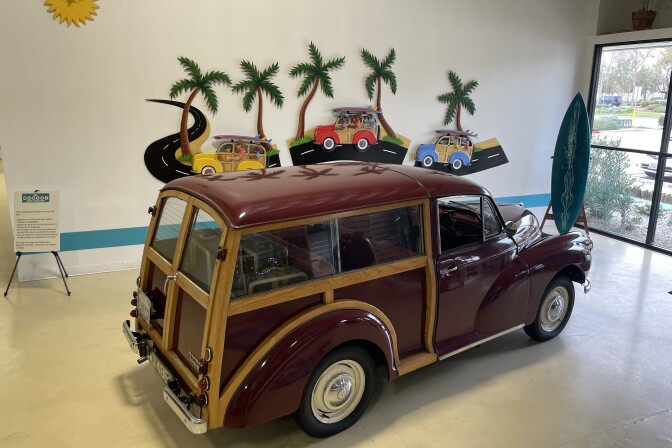 A classic magenta car in an indoor space.