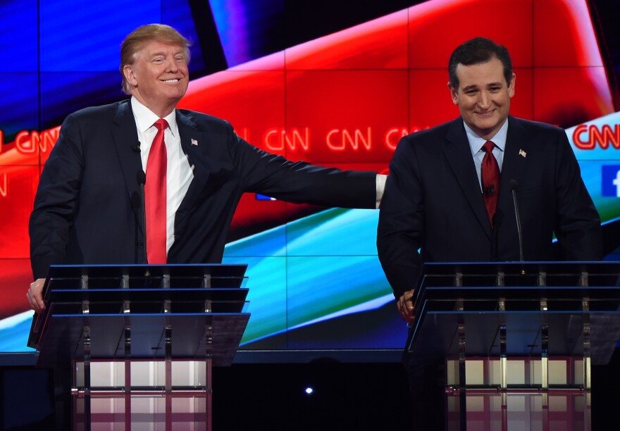 Republican presidential candidate businessman Donald Trump (L) pat the back of Texas Sen. Ted Cruz during the Republican Presidential Debate, hosted by CNN, at The Venetian Las Vegas on December 15, 2015 in Las Vegas, Nevada. AFP PHOTO/ ROBYN BECK / AFP / ROBYN BECK        (Photo credit should read ROBYN BECK/AFP/Getty Images)
